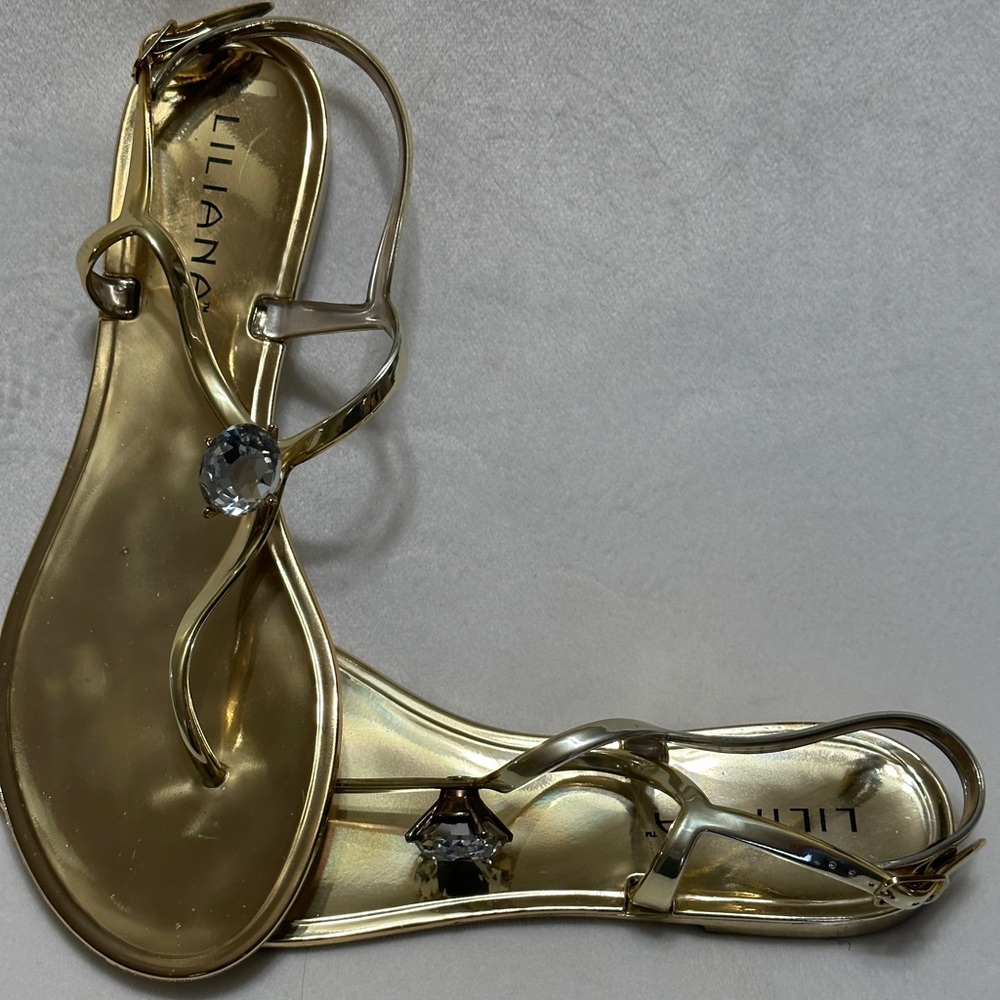 Gold sandals with a diamond stud in the middle